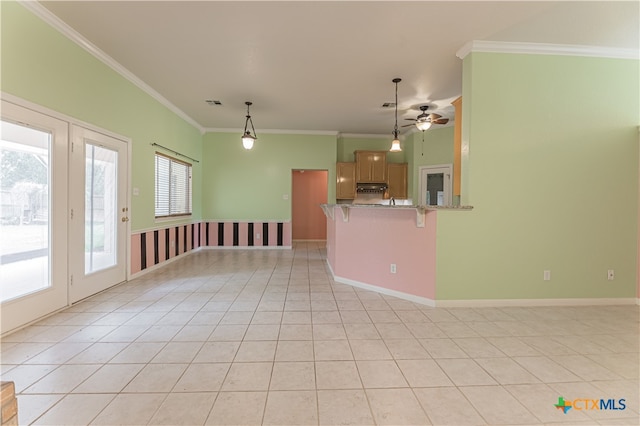 unfurnished living room with light tile patterned flooring, ceiling fan, and ornamental molding