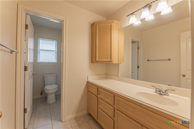 bathroom featuring toilet, vanity, and tile patterned floors