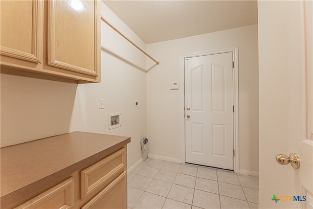 clothes washing area featuring cabinets, washer hookup, light tile patterned floors, and electric dryer hookup