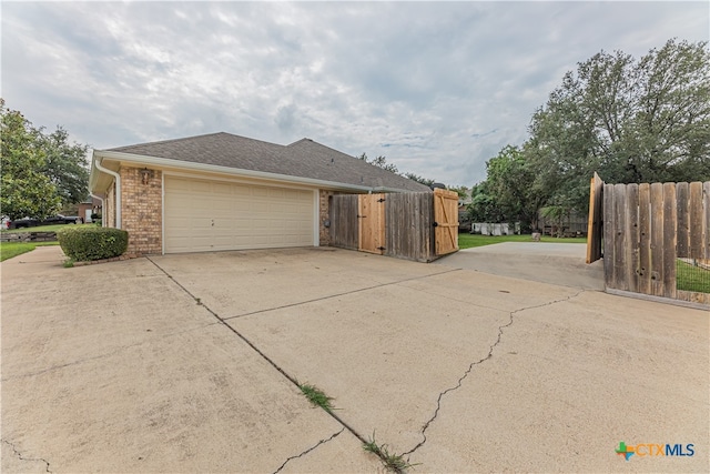 view of side of home featuring a garage