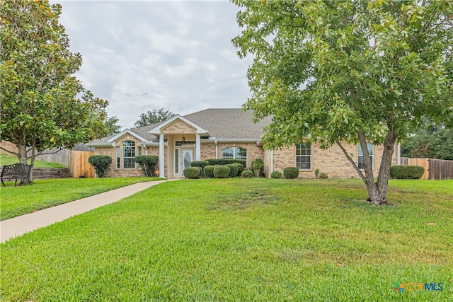 single story home featuring a front lawn