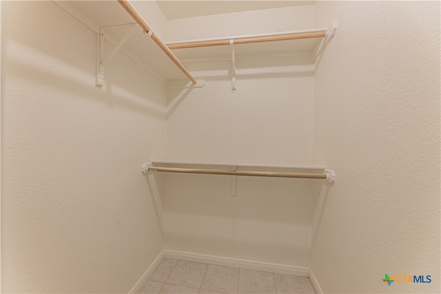 spacious closet featuring light tile patterned flooring