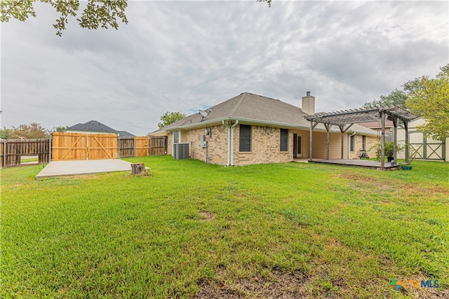 rear view of property featuring a lawn, a patio, and a pergola