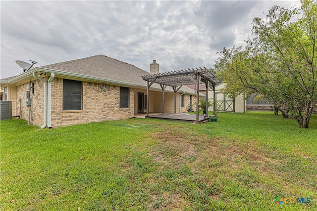 back of house with cooling unit, a pergola, a yard, and a patio area