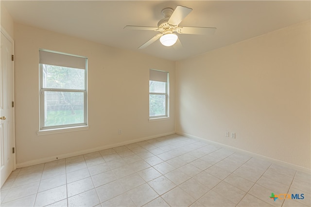 empty room featuring light tile patterned flooring and ceiling fan