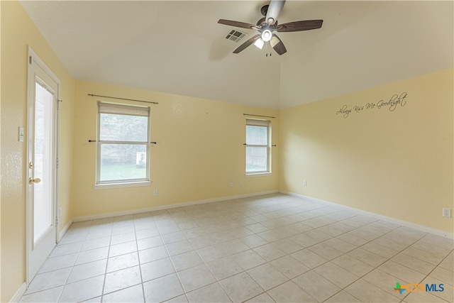 tiled empty room featuring ceiling fan and vaulted ceiling