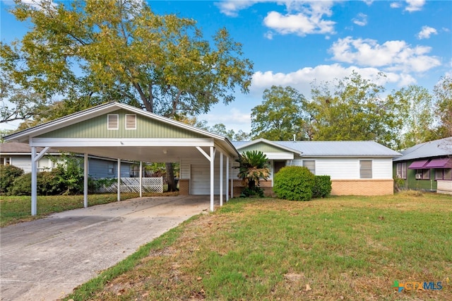 view of front facade with a front yard and a carport