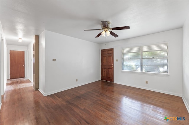 empty room featuring ceiling fan and dark hardwood / wood-style flooring