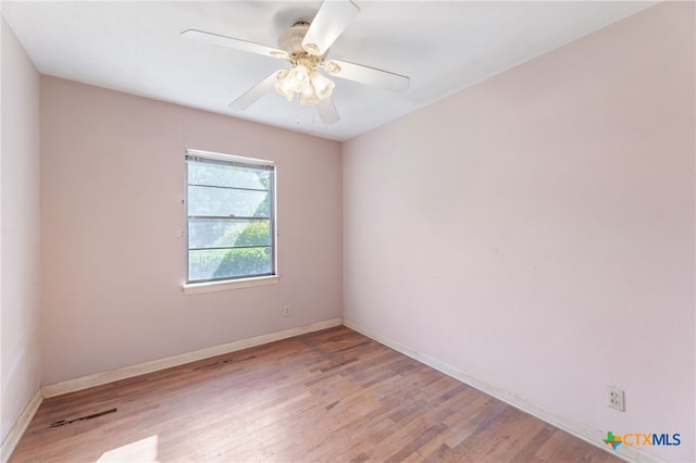 spare room featuring light wood-type flooring and ceiling fan