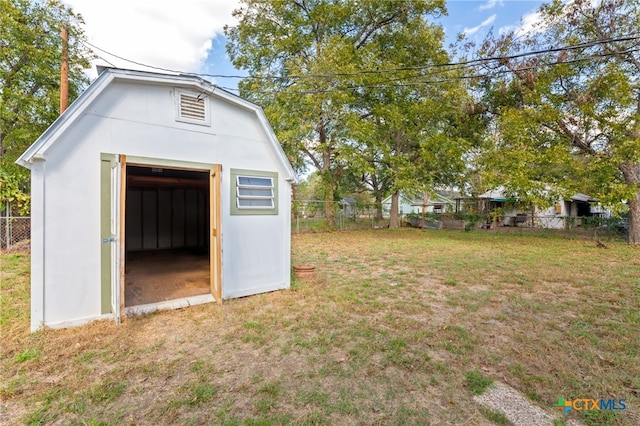 view of outdoor structure featuring a lawn