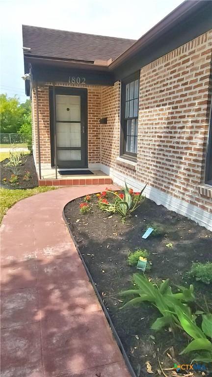 property entrance with brick siding