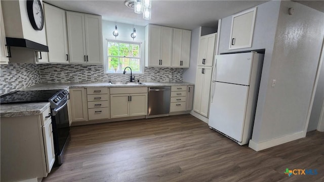 kitchen with tasteful backsplash, a sink, black range with electric cooktop, dishwasher, and freestanding refrigerator