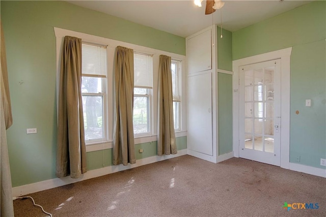 empty room featuring carpet and baseboards