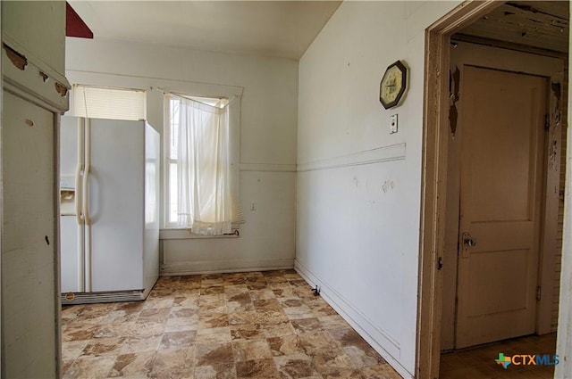 interior space featuring stone finish floor and baseboards