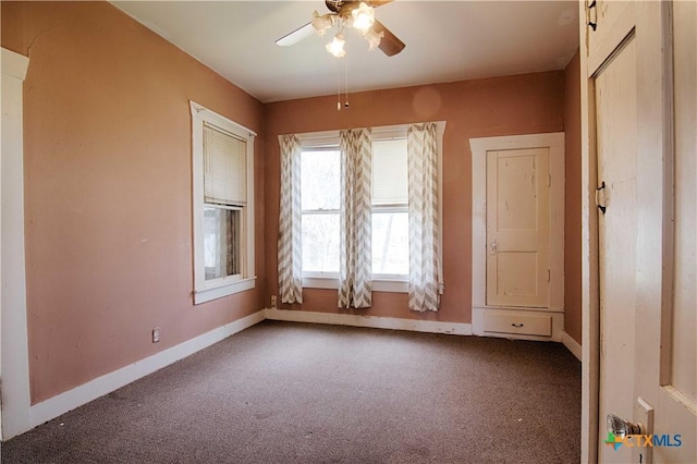 spare room with carpet flooring, ceiling fan, and baseboards