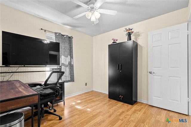 home office with ceiling fan, light wood-type flooring, and baseboards