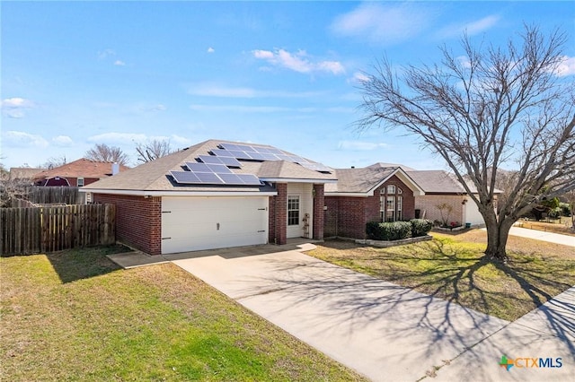 single story home with a garage, brick siding, a front yard, and fence