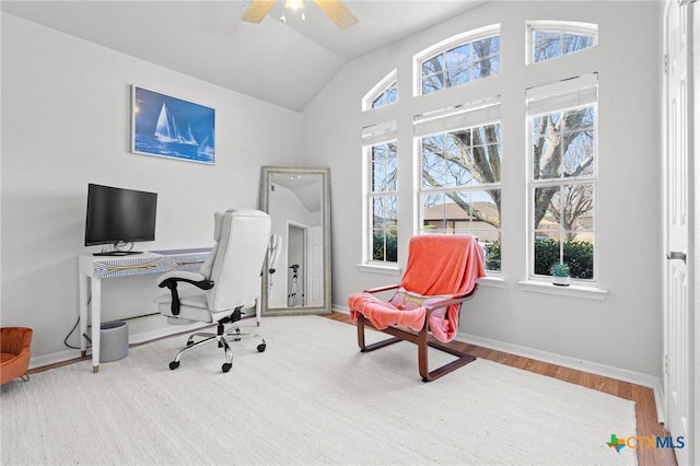 office area featuring vaulted ceiling, ceiling fan, wood finished floors, and baseboards