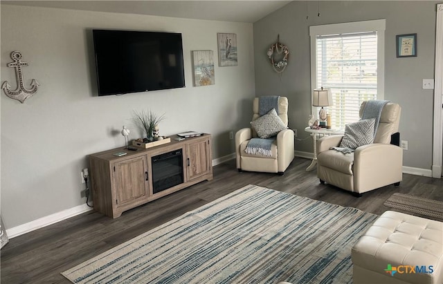 living room with lofted ceiling, baseboards, and dark wood-style flooring