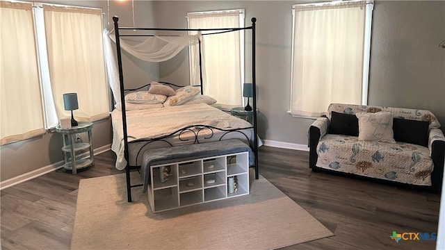 bedroom featuring baseboards and wood finished floors