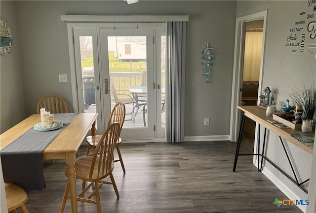 dining area with baseboards and dark wood-style flooring