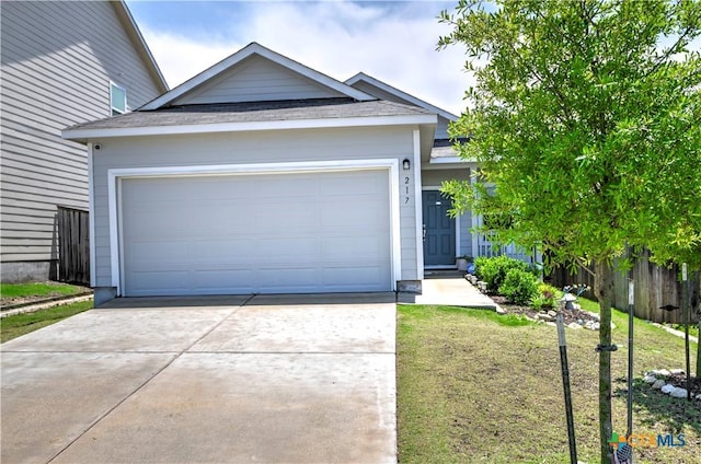 view of front of house with concrete driveway, a garage, and roof with shingles