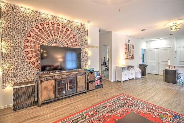living area featuring wood finished floors and baseboards