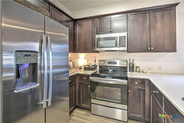 kitchen featuring stainless steel appliances and dark brown cabinets