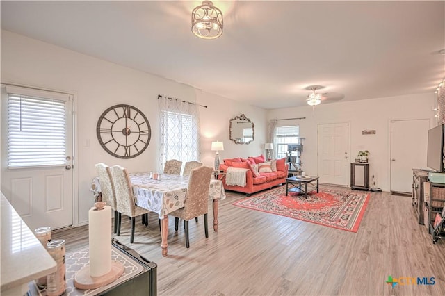 dining area featuring light wood-style flooring and a ceiling fan