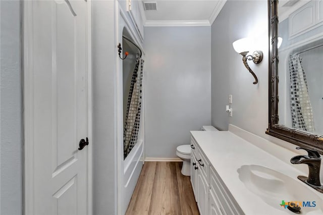 full bath with toilet, wood finished floors, vanity, visible vents, and ornamental molding