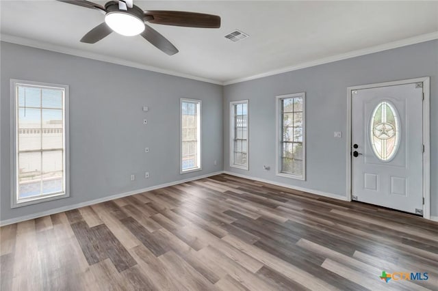 entrance foyer featuring visible vents, crown molding, baseboards, and wood finished floors