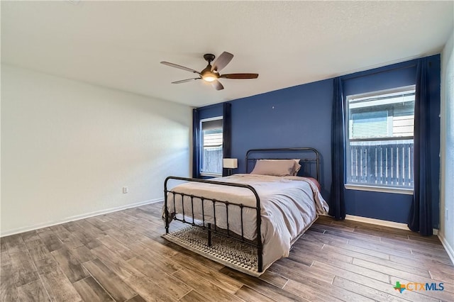 10122 Divine Breeze, San Antonio, TX 78251 - bedroom with wood finished floors, multiple windows, and a ceiling fan