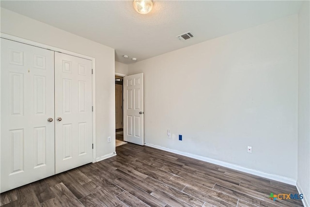 10122 Divine Breeze, San Antonio, TX 78251 - unfurnished bedroom featuring dark wood-type flooring and a closet