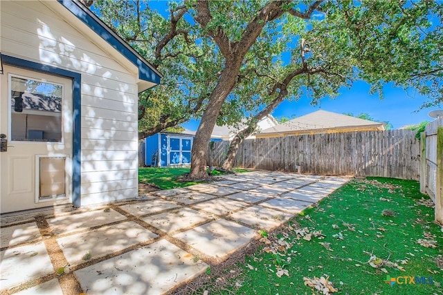 10122 Divine Breeze, San Antonio, TX 78251 - fenced backyard featuring a patio area and a storage shed
