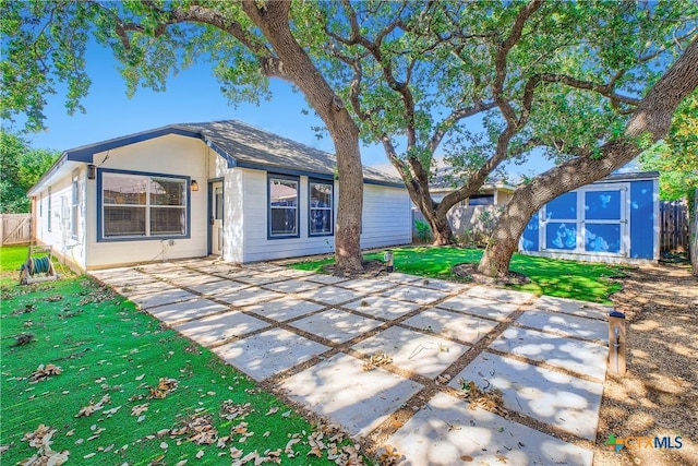 10122 Divine Breeze, San Antonio, TX 78251 - rear view of property with a storage shed, a patio, and a fenced backyard