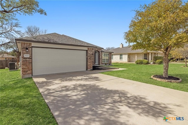 ranch-style home featuring central AC unit, an attached garage, brick siding, driveway, and a front yard