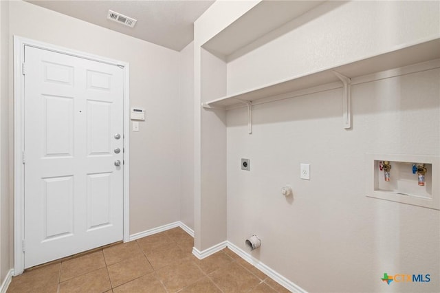 washroom featuring light tile patterned floors, hookup for an electric dryer, laundry area, washer hookup, and visible vents