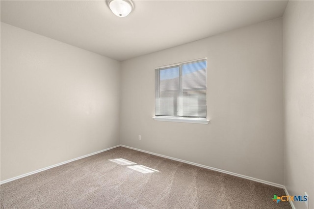 carpeted empty room with baseboards