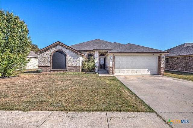 single story home with a garage and a front lawn