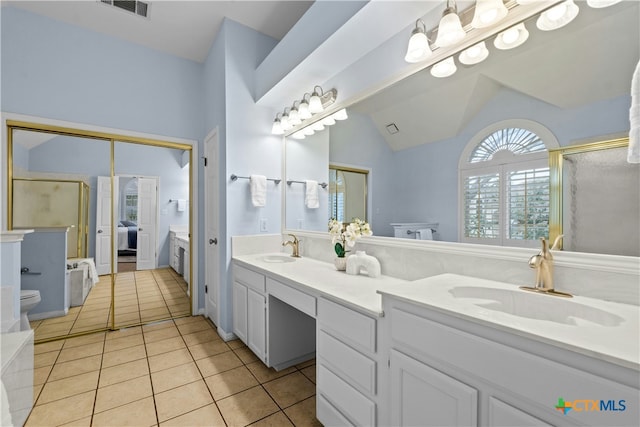 full bathroom featuring a stall shower, a sink, visible vents, and tile patterned floors