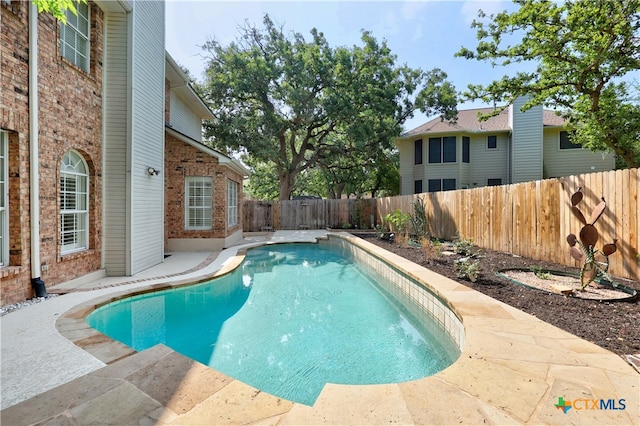 view of swimming pool featuring a patio area, a fenced backyard, and a fenced in pool