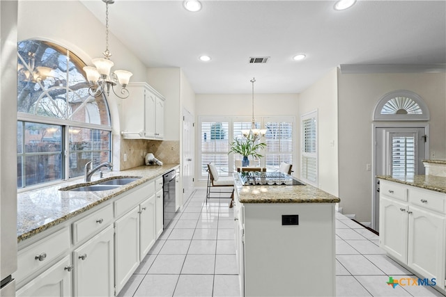 kitchen featuring a center island, a notable chandelier, visible vents, a sink, and black appliances