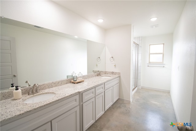 bathroom with an enclosed shower, vanity, and concrete floors