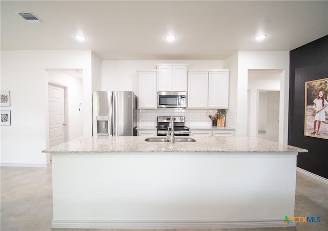 kitchen featuring white cabinetry, an island with sink, and stainless steel appliances