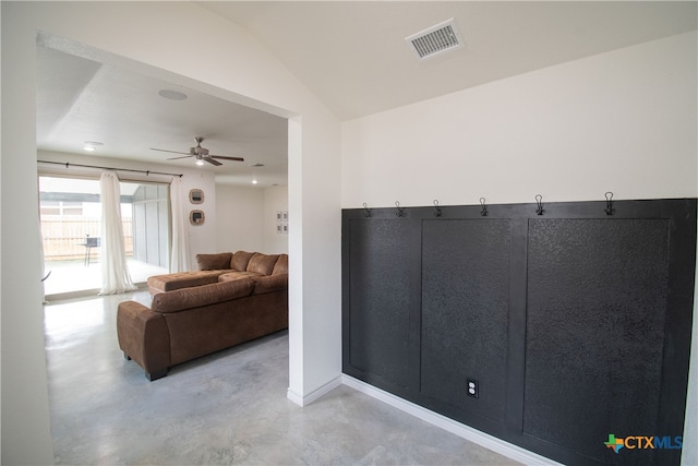 living room featuring ceiling fan and vaulted ceiling