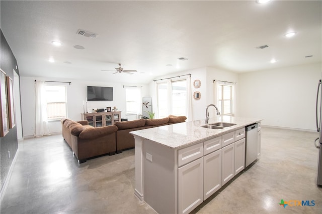 kitchen featuring white cabinetry, sink, a healthy amount of sunlight, an island with sink, and dishwasher