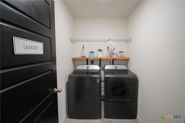 clothes washing area with washer and clothes dryer