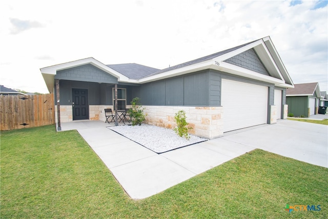 ranch-style home featuring a garage and a front lawn