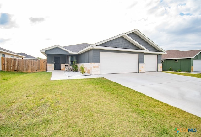 view of front of property with a garage and a front yard