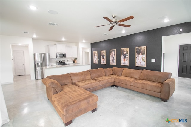 living room with sink and ceiling fan